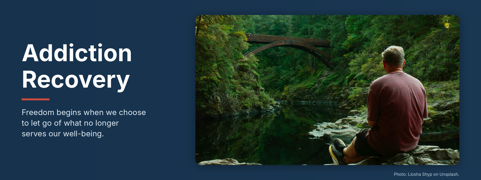 Addiction Recovery banner with a man sitting on rocks looking at a forest bridge over a calm river
